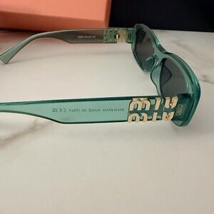 Miu Miu Translucent Teal Acetate Sunglasses with Gold Logo Temples